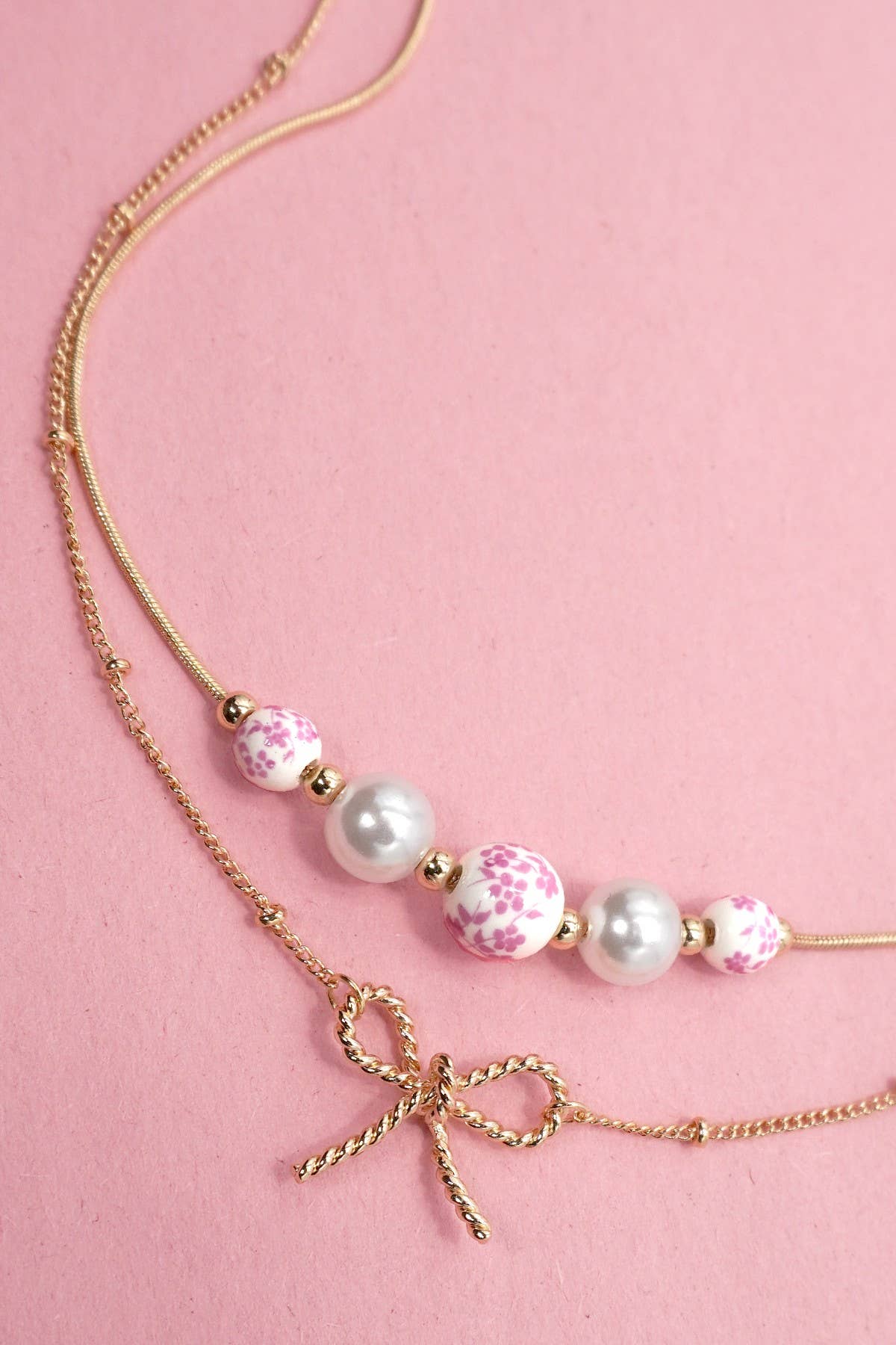 JOSSLYN by Wall to Wall - PINK CERAMIC PORCELAIN PEARL BOW LAYER NECKLACE | 80N91556