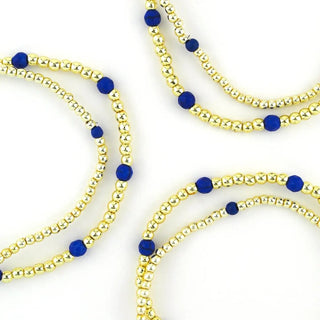 Tatum Starter Stack of gold beaded bracelets with blue accents