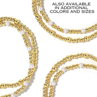 Penny Starter Stack of gold beaded bracelets with white accents