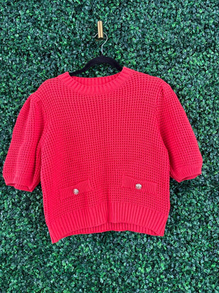 Entro reddish coral sweater with gold buttons, front view